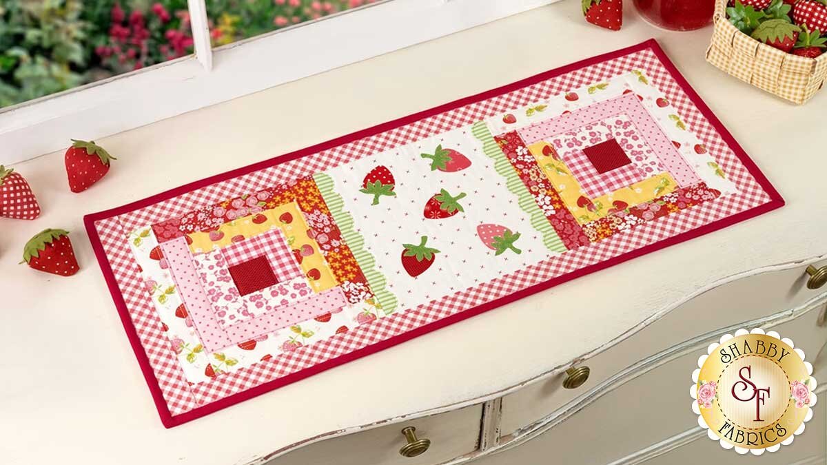 sew_cute_june_hero.jpg The finished June Sew Cute Runner, with log cabin blocks and pre-fused strawberry applique.