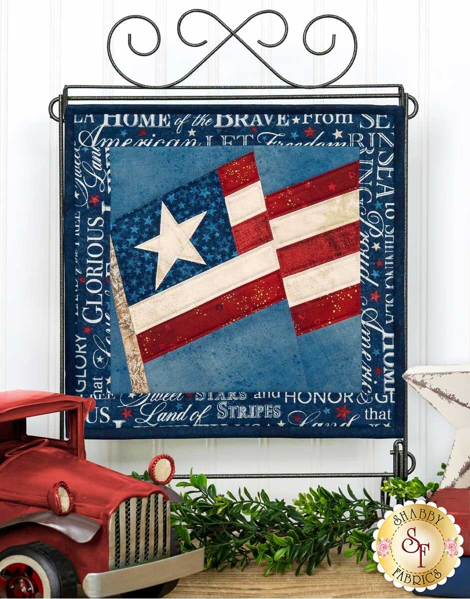 fpp_series_4_july_hero.jpg The finished July foundation paper pieced American flag block displayed on a stand.