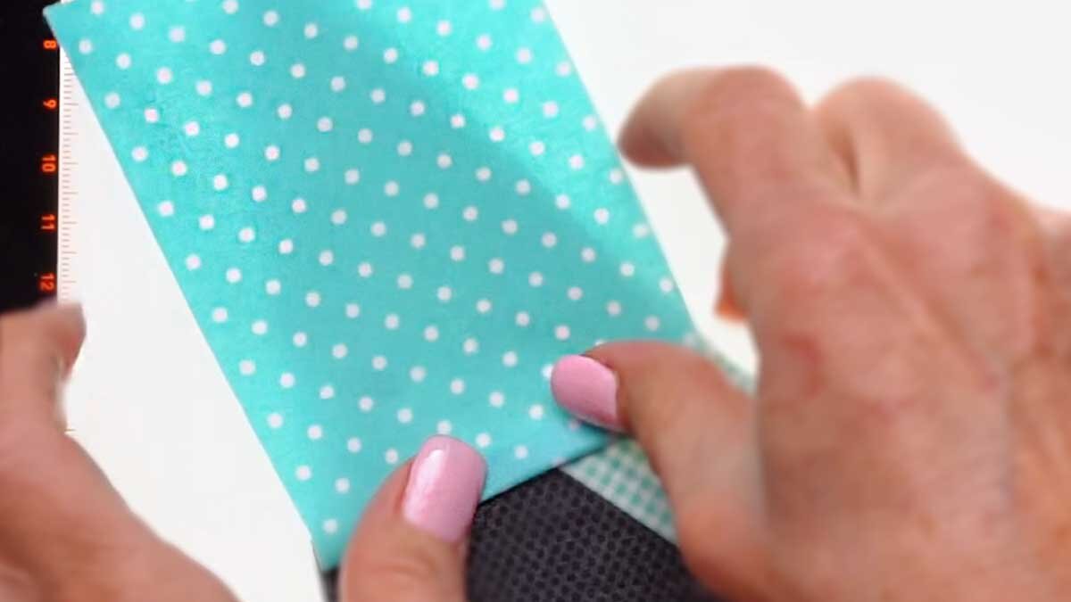 fpp_august_4_folding_to_cover.jpg A fabric piece held to the light source and flipped open to check that it will cover its shape once sewn.