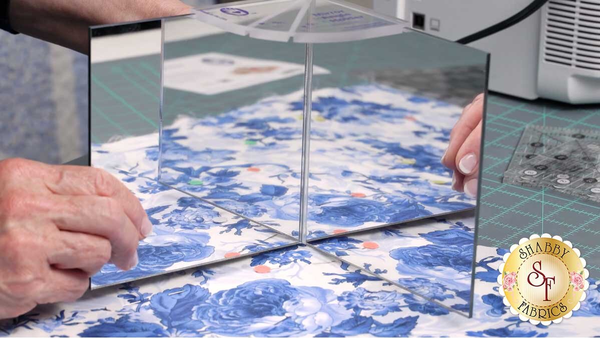keyboard_kaleidoscope_bom_magic_mirror.jpg A pair of magic mirrors placed on the fabric, previewing how the design will look spun into a four patch kaleidoscope.